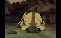 an animated character sitting in the grass with his back turned to look like he has fallen