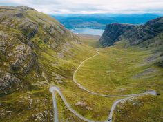 an aerial view of a winding road in the mountains