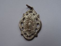 Religious antique French medal pendant of NDL ( Notre Dame De Lourdes ) Holy Mary of Lourdes. At the other side is Holy Mary. Measures: 0,74 x 1,09 inch ( 1,88 cm x 2,77 cm ) I bought them on a brocante (fleamarkets ) in France. I deliver all over the world. Registered shipping is possible. If you haven't Paypal, you can pay by bank transfer. I have a lot of this medals. If you have a question feel free to ask. Please take also a look at my other items for sale.Registered shipping is possible an Silver Miraculous Medal Pendant, Silver Pendant With Miraculous Medal, Our Lady Of Sorrows, Catholic Medals, Holy Mary, Miraculous Medal, Bank Transfer, Flea Market, Items For Sale