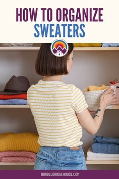 a woman standing in front of a closet filled with clothes and holding a basket full of sweaters