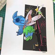 a drawing of tinkerbell and firework on a piece of paper next to markers