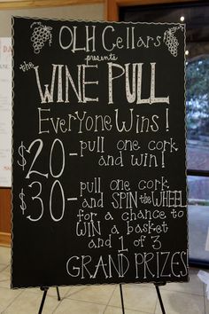 a sign that is on top of a stand in front of a window with wine prices