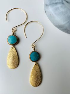 Unique ear wire turquoise earring with brass tear drops finish. Fun and whimsical! Turquoise Dangle Jewelry With French Hook, Turquoise Nickel-free Brass Jewelry, Turquoise Wire Wrapped Teardrop Dangle Earrings, Turquoise Teardrop Earrings For Jewelry Making, Bronze Metal Teardrop Earrings, Unique Turquoise Teardrop Earrings, Nickel Free Brass Teardrop Pendant Jewelry, Bohemian Turquoise Teardrop Drop Earrings, Turquoise Bohemian Teardrop Earrings