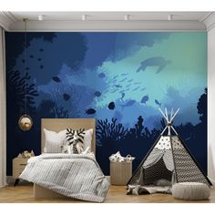 a bedroom with an underwater scene painted on the wall next to a teepee tent