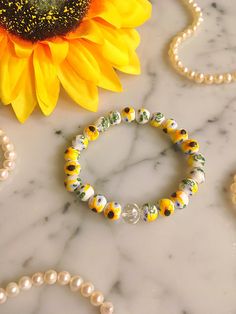 Handmade ceramic Sunflower bead stretch bracelet. Features a clear glass crystal accent bead. The bracelet measures approximately 7" before stretching. Cheap Yellow Flower-shaped Beaded Bracelets, Ceramic Sunflower, Sunflower Bracelet, Sunflower Jewelry, Pretty Earrings, Beaded Stretch Bracelet, Glass Crystal, Jewelry Vintage, Handmade Ceramic