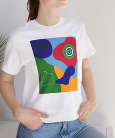 This tee features blue, red, yellow, and green abstract shapes with design elements that have been put together in an abstract collage. Stand out from the others with this bright and colorful t-shirt.  This makes a great gift for the art teacher, for the contemporary art lover, or for the art enthusiast.   This classic unisex jersey short sleeve tee fits like a well-loved favorite. Soft cotton and quality print make users fall in love with it over and over again. These t-shirts have-ribbed knit collars to bolster shaping. The shoulders are tapered for a better fit over time. Dual side seams hold the garment's shape for longer.  .: Made with 100% Airlume combed and ring-spun cotton, a lightweight fabric (4.2 oz/yd² (142 g/m that is easy to layer, breathable. Perfect for active and leisure w Multicolor Abstract Print Casual T-shirt, Cotton Graphic Tee With Abstract Print, Artistic Multicolor Crew Neck T-shirt, Artistic Cotton T-shirt With Abstract Print, Artsy Multicolor Screen Print T-shirt, Artistic Multicolor Tops With Graphic Print, Artsy Multicolor Tops With Abstract Print, Casual Multicolor Abstract Print T-shirt, Artsy Multicolor Screen Print Tops