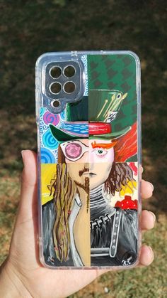 a person holding up a phone case with a painting on it