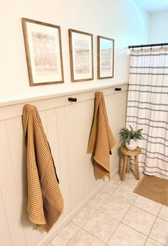 three towels hanging on the wall in a bathroom