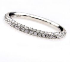 a diamond wedding band on a white background