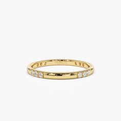 a yellow gold ring with diamonds on it