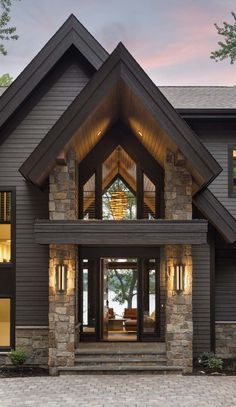 a large house with stone and wood accents