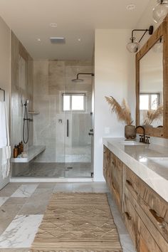 a large bathroom with two sinks and a walk in shower