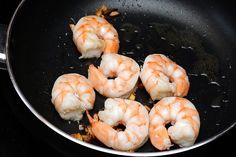 shrimp being cooked in a frying pan on the stove