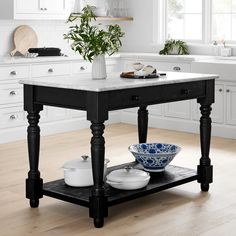 a black and white kitchen island with two bowls on it