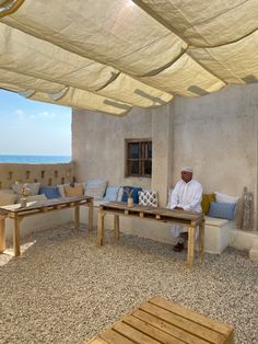 a man sitting on a couch under an awning