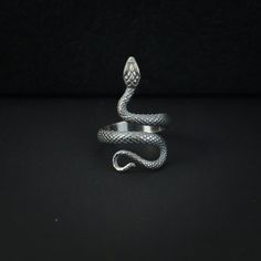 Introducing our Snake Ring, a captivating accessory crafted from pure 925 sterling silver. The ring showcases a meticulously carved serpent, elegantly winding its way around your finger. The entire snake motif is intricately detailed, and the antique finish, achieved through careful handcrafting, adds a timeless allure.  Materials: 925 Sterling Silver Ring Weight: 4.3g Ring Height: 1.17" Ring Size: Adjustable 9-12 US ☛ This silver men necklace suitable for any occasion and everyday wear ☛ This men jewelry is a very special gift for valentine's day gifts, birthday gifts, wedding gifts, Christmas gifts, party, anniversary gifts and more ☛ Comes with an exquisite gift box ----♛ PRODUCTION & SHIPPING ♛ --- ☛ Multiple items purchased in one payment can be combined for shipping ☛ Visit our store Sterling Silver Snake Ring, Sterling Silver Snake Ring Gift, Adjustable Symbolic Snake Ring, Elegant Silver Snake Ring For Collectors, Silver Symbolic Snake Shaped Ring, Luxury Snake-shaped Rings For Gifts, Silver Symbolic Snake Ring, Silver Hallmarked Snake Ring For Gift, Snake-shaped Metal Rings As A Gift