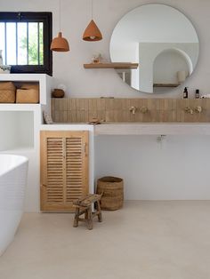 a bathroom with a sink, mirror and stool