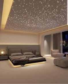 a large bed sitting in a bedroom next to a window with stars on the ceiling