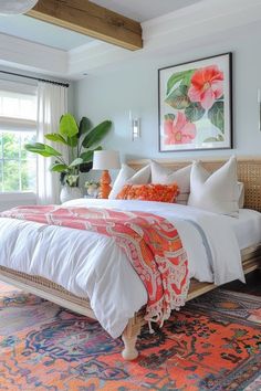 a bedroom with a bed, rugs and paintings on the wall in front of it