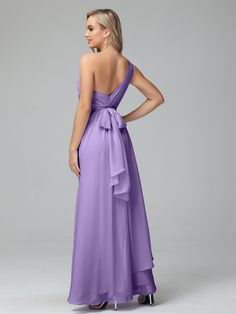 a woman in a long purple dress with a backless neckline and bow at the waist