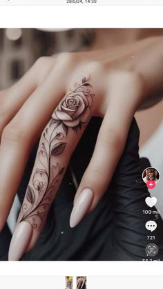 a woman's hand with a rose tattoo on it