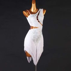 a mannequin wearing a white dress with fringes