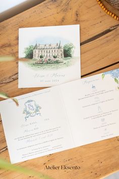 the wedding stationery is laid out on a wooden table