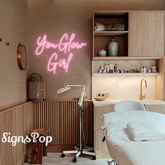 a hospital room with a neon sign that says you're your glob