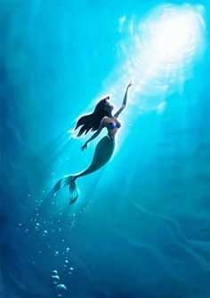 the little mermaid is swimming under water