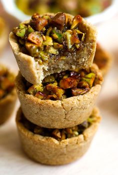 there are several small pies stacked on top of each other with nuts in them