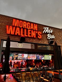 the entrance to morgan wallen's bar and grill at night with neon signs