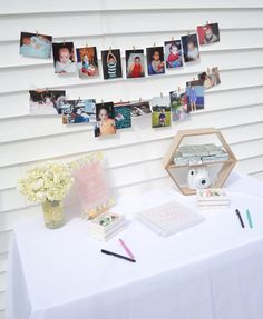 a white table topped with pictures and flowers