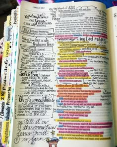 an open bible with writing on it and colorful markers all over the page in each section