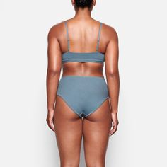 This is one bra you’ll never want to take off. In our ultra soft and lightweight jersey fabric, this scoop neck bralette features an elastic band and hook-free design for a comfortable fit. Perfect for layering or wearing on its own. | SKIMS Scoop Bralette | Blue | Small | Cotton Jersey Oversized Tote Bag, Rugby Shirt, Style Gift, Lingerie Sleepwear, Boy Shorts, World Of Fashion, Jersey Fabric, Elastic Band, Print Tops