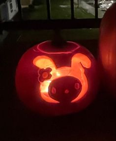 two pumpkins that have been carved to look like mickey mouse and pluto the pooh