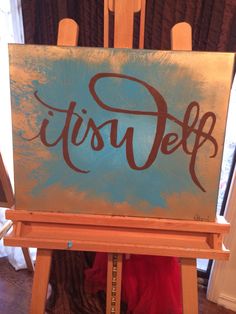 an easel with a blue and brown sign that says tiself on it