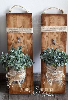 two wooden boxes with plants in them and tied to each other on top of a table