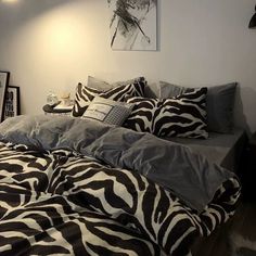 a zebra print comforter on a bed in a bedroom