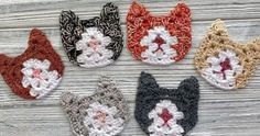 six crocheted cat ears are arranged in different colors and sizes on a wooden surface