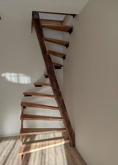 a wooden stair case in an empty room