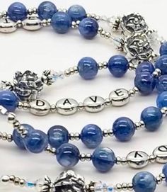 Create a one-of-a-kind heirloom wedding gift for the bride and groom! Include the first names of the bride and groom. Due to the number of beads in a rosary decade, there is a maximum of 10 letters in each name. The standard bead selections are either eggshell white Swarovski crystal pearls ($255 rosary) or beautiful blue kyanite gemstones ($355 rosary). The "Our Father" beads are sterling silver roses to honor Our Lady who is often associated with the flower. The sterling center is the Blessed Spiritual Beaded Jewelry For Anniversary, Elegant Rosary With Round Beads For Healing, Spiritual Wedding Jewelry With 8mm Beads, Elegant Healing Rosary With Round Beads, Adjustable Elegant Rosary, Elegant Adjustable Rosary, Silver Oval Beaded Jewelry For Wedding, Spiritual 8mm Beads Jewelry For Wedding, Adjustable Polished Beads Jewelry For Anniversary