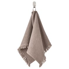 a tan towel hanging from a hook on a white wall