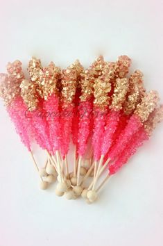 small pink and gold sparkle sticks on white background