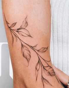 a woman's leg with leaves on it