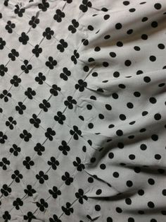 black and white polka dot fabric with flowers on it