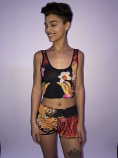 These comfortable and cute cropped bralets can be worn with the matching sports bra for added support. Paired with one of the many matching shorts, this top can be worn in the studio, as a bathing suit or out on the street. double sided with 2 different yet complimenting prints, made from recycled water bottles and spandex UV protection Moisture-wicking Crop Top Activewear For Summer, Sporty Crop Top With Built-in Shorts, Sporty Crop Top With Built-in Shorts For Gym, Summer Sports Tank Top With Built-in Shorts, Casual Sports Crop Top With Built-in Bra, Sleeveless Orange Activewear For Summer, Athleisure Crop Top With Built-in Bra For Beach, Summer Moisture-wicking Crop Top Activewear, Trendy Racerback Crop Top For Sports