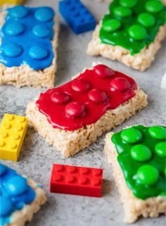 lego rice krispy treats are arranged on top of each other, with candy in the middle