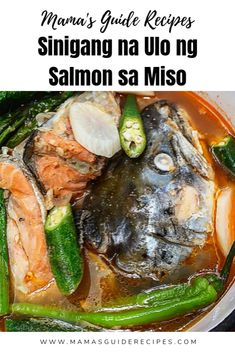 a bowl filled with fish and veggies on top of a table