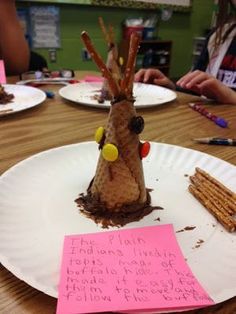 a paper plate with a tree made out of crackers on it and a note attached to the top