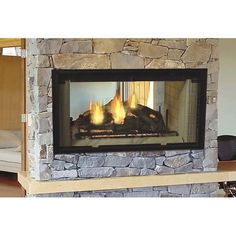 a fire place in a living room next to a couch and fireplace with candles on it